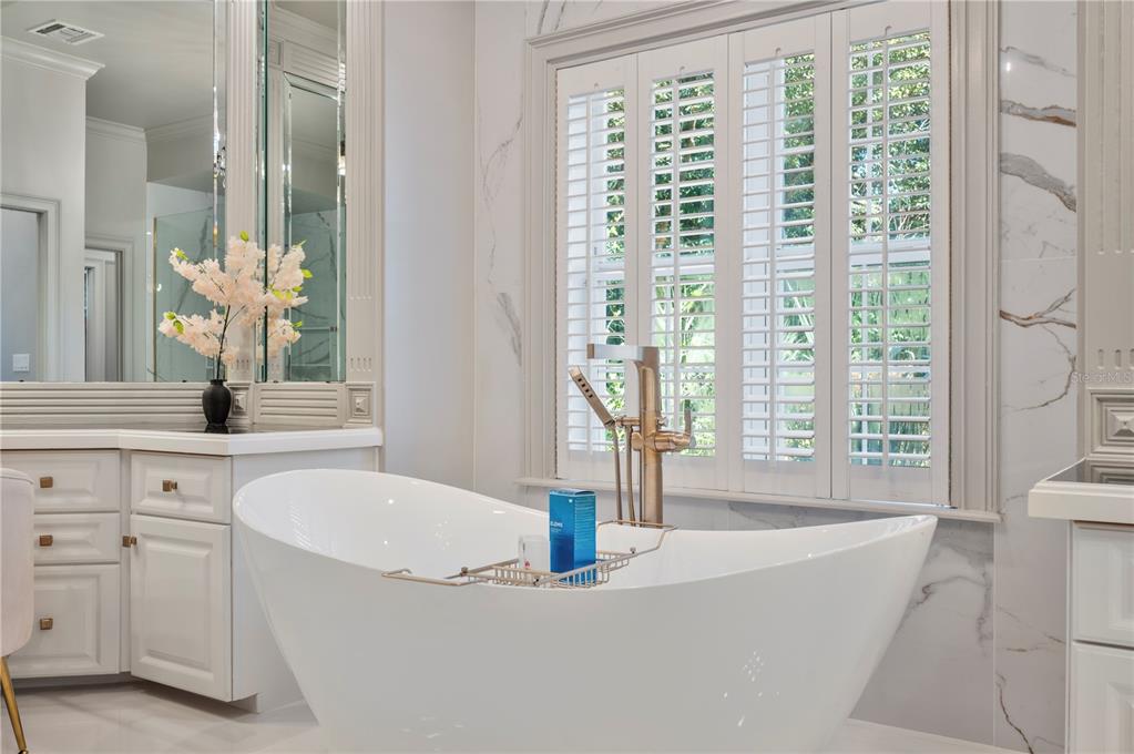 1909 New Jersey Road Lakeland, FL 33803 - Photo 50 of 93 a bath tub sitting in a bathroom next to a window