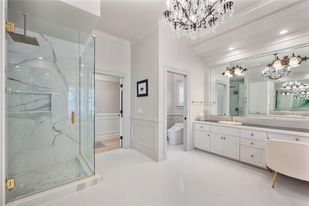 1909 New Jersey Road Lakeland, FL 33803 - Photo 50 of 93 a bathroom with a granite countertop sink a large mirror and a shower