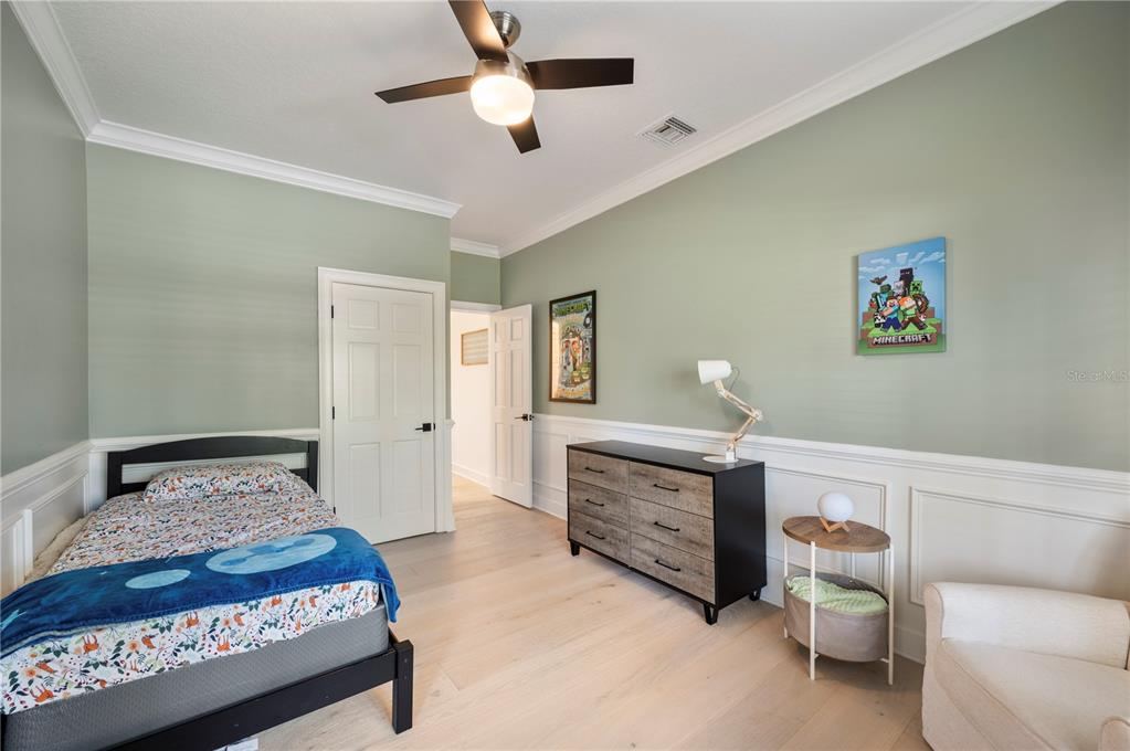 1909 New Jersey Road Lakeland, FL 33803 - Photo 55 of 93 a bedroom with a bed and a chandelier