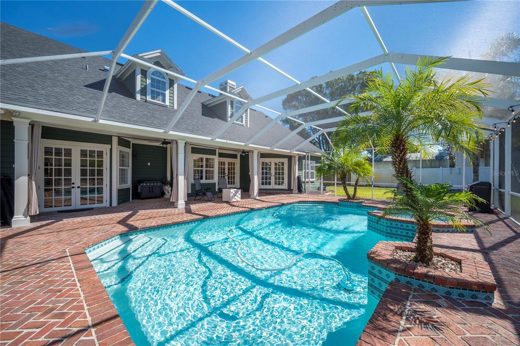 1909 New Jersey Road Lakeland, FL 33803 - Photo 69 of 93 a front view of a house with swimming pool outdoor seating and barbeque oven