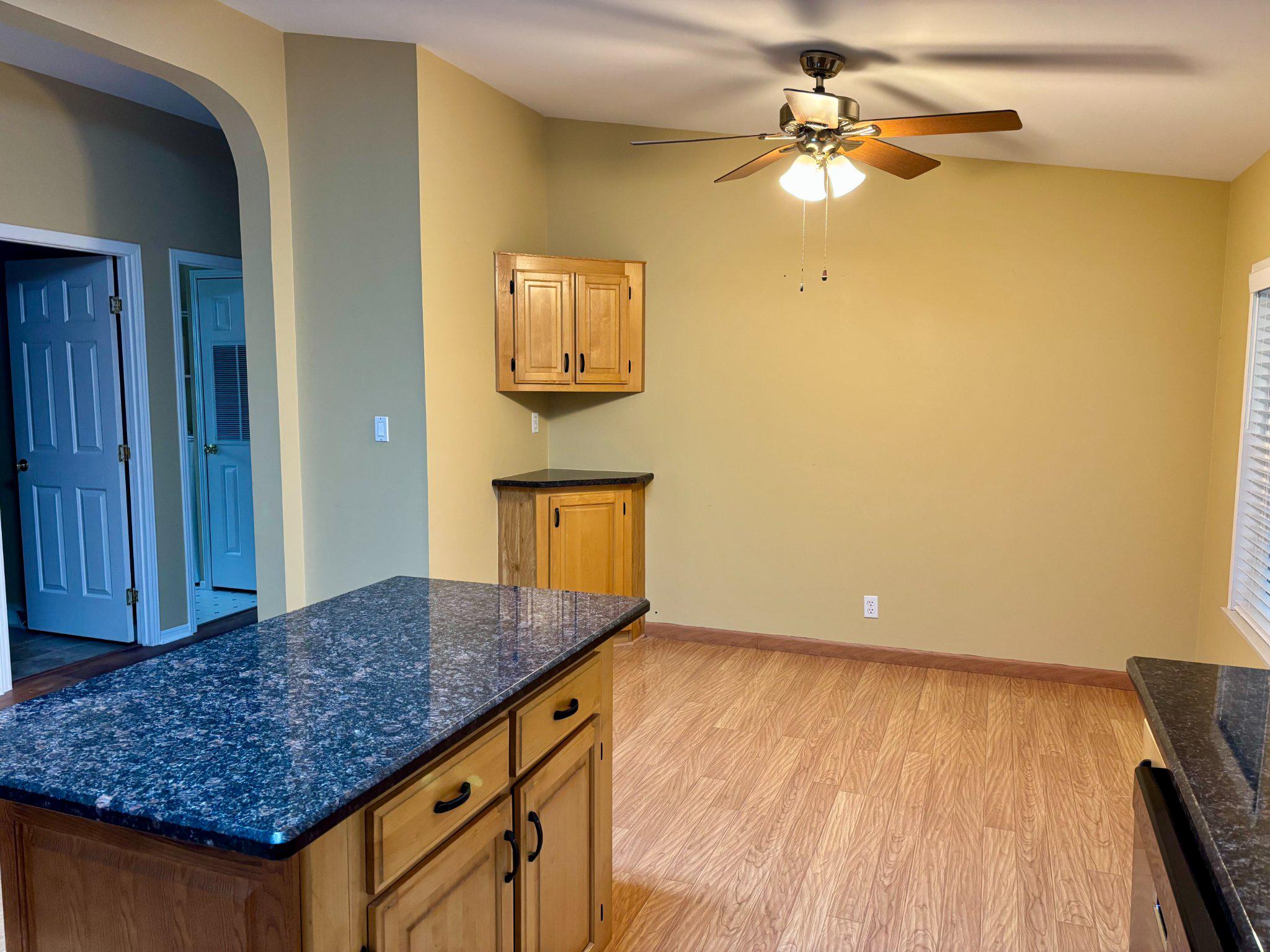 399 Spring Meadow Circle New Hope, PA 18938 - Photo 12 of 37 a view of kitchen island with wooden floor and ceiling fan