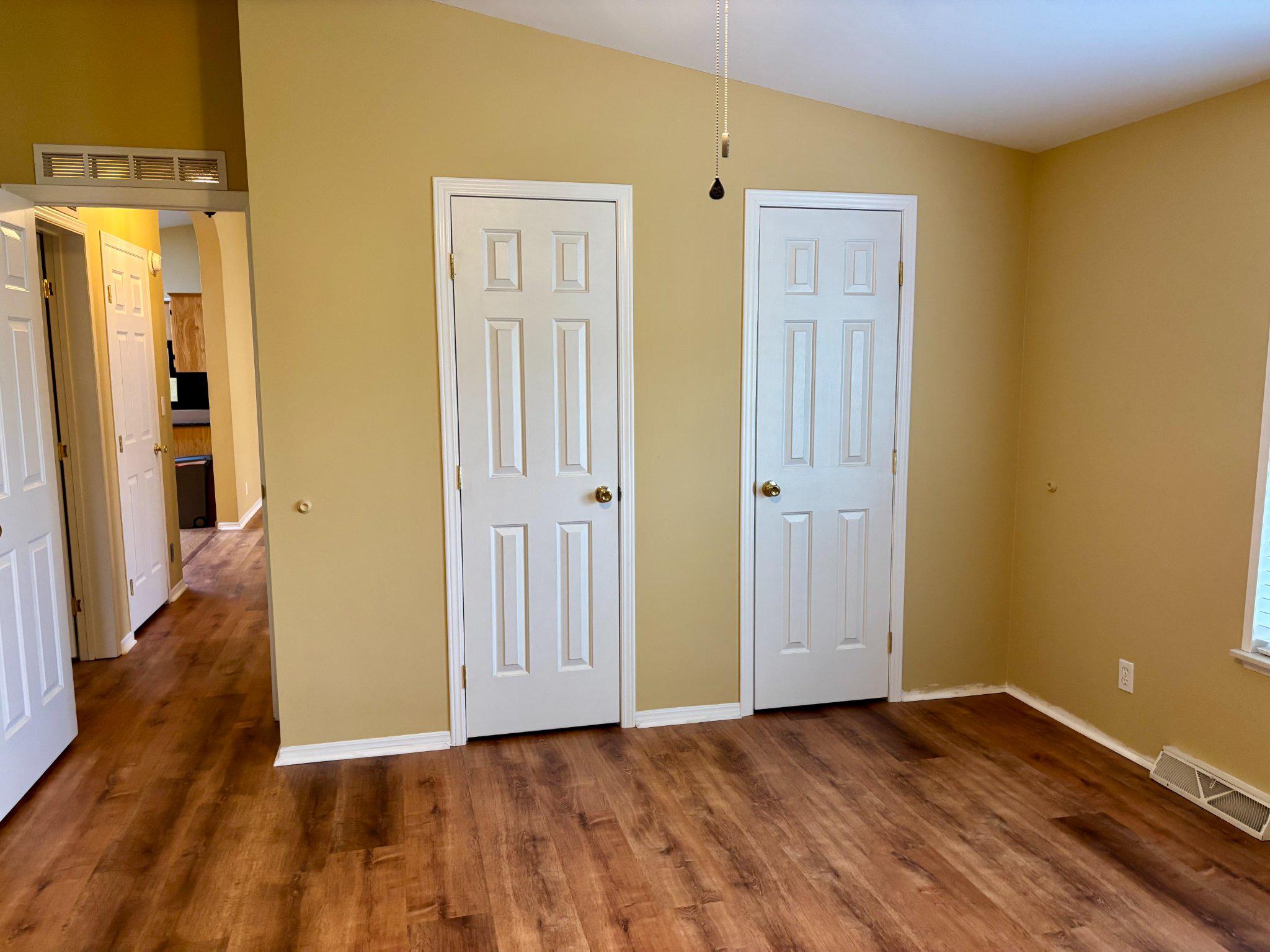 399 Spring Meadow Circle New Hope, PA 18938 - Photo 19 of 37 an empty room with wooden floor and a bathroom