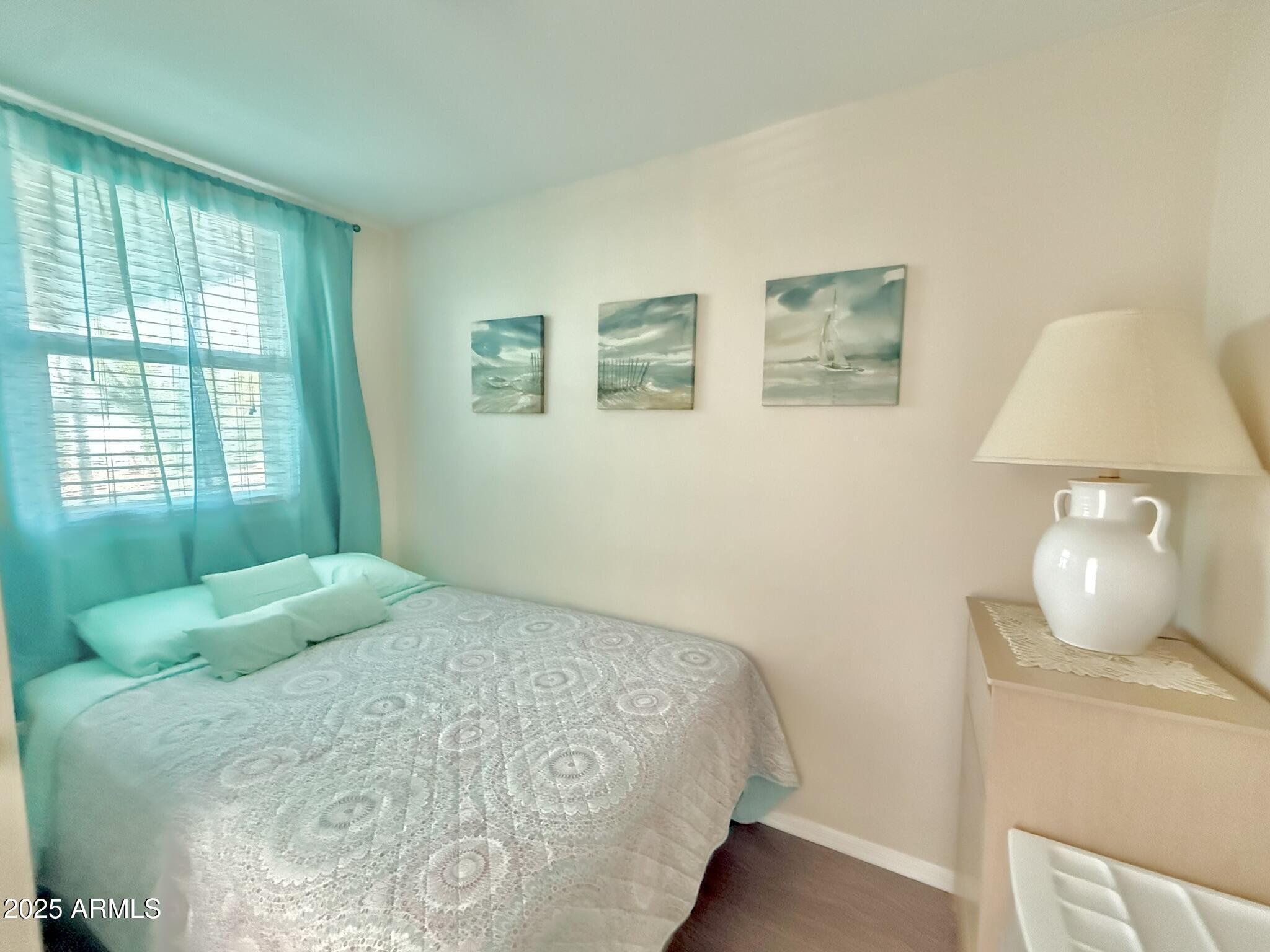 8865 East Baseline Road, Unit 1643 Mesa, AZ 85209 - Photo 17 of 44 a bedroom with a bed and a lamp