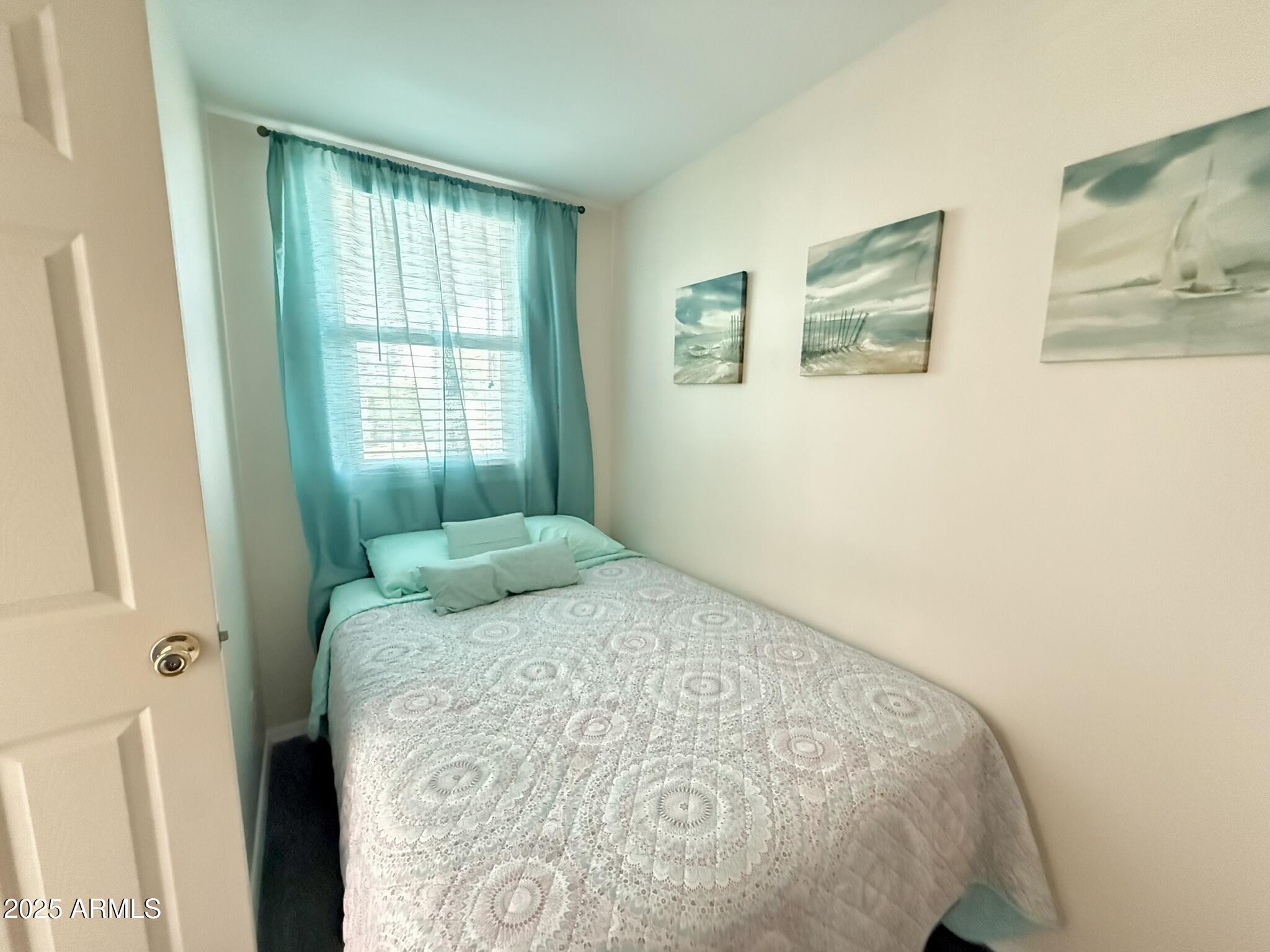 8865 East Baseline Road, Unit 1643 Mesa, AZ 85209 - Photo 18 of 44 a bedroom with a bed and a window