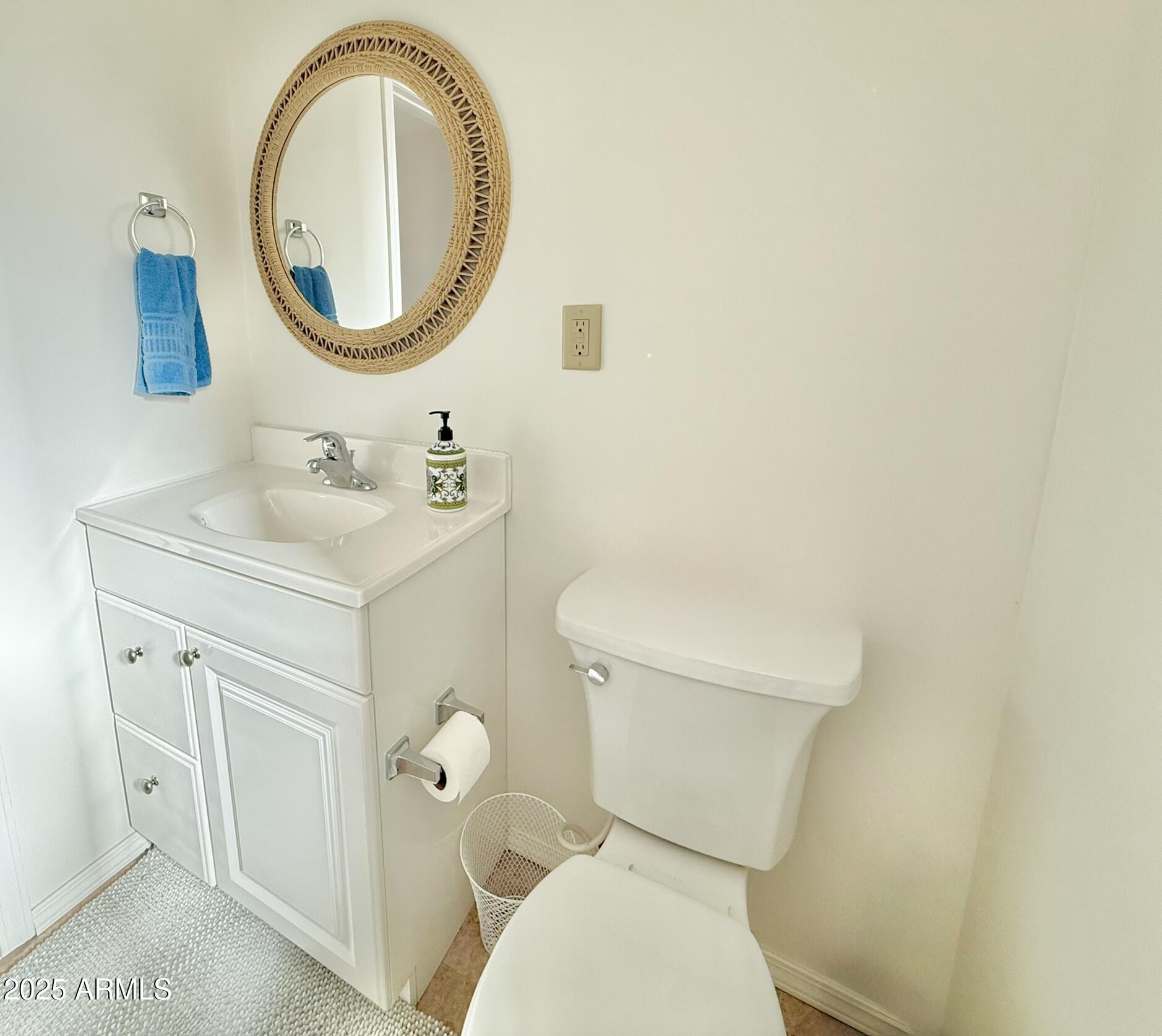 8865 East Baseline Road, Unit 1643 Mesa, AZ 85209 - Photo 19 of 44 a bathroom with a toilet a sink and a mirror