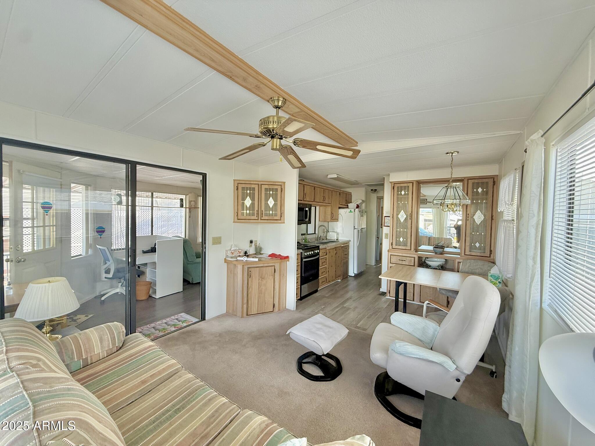 8865 East Baseline Road, Unit 1643 Mesa, AZ 85209 - Photo 2 of 44 a living room with furniture and wooden floor