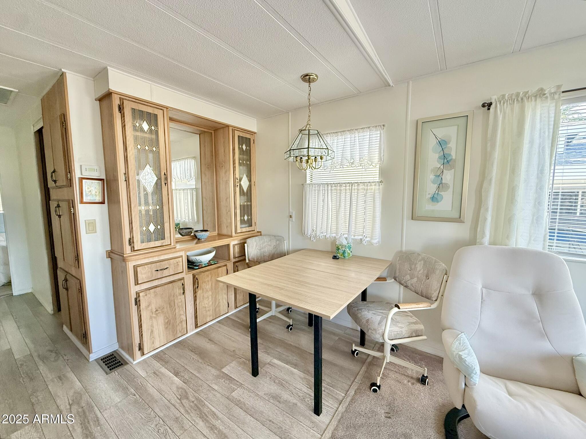 8865 East Baseline Road, Unit 1643 Mesa, AZ 85209 - Photo 4 of 44 a view of a a dining room with furniture window and wooden floor