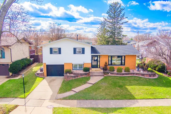 a view of a house with a yard porch and sitting area
