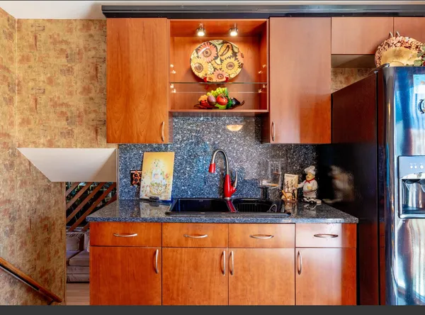 a kitchen with stainless steel appliances granite countertop a stove and a refrigerator