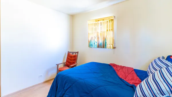 a view of a bedroom with furniture and closet