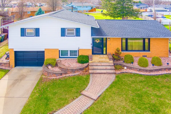 a front view of a house with a garden and patio