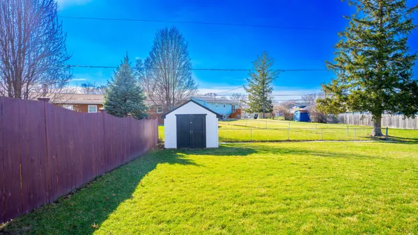 a view of a house with a backyard