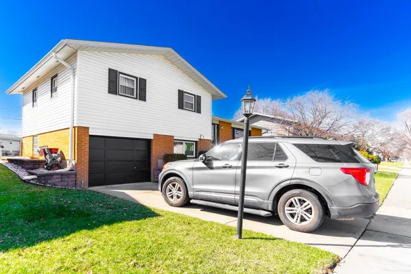 a blue house with trees in the background