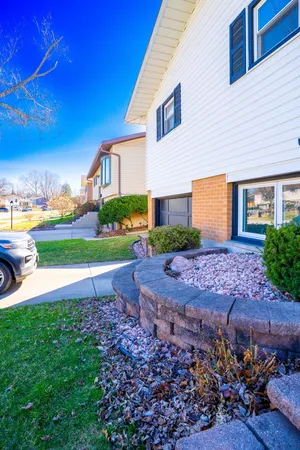 a front view of a house with a garden and yard