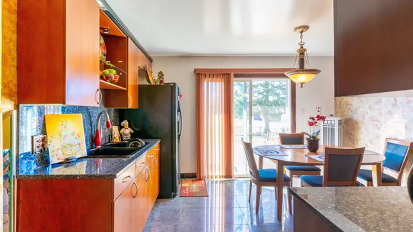 a kitchen with stainless steel appliances granite countertop sink stove top oven and cabinets