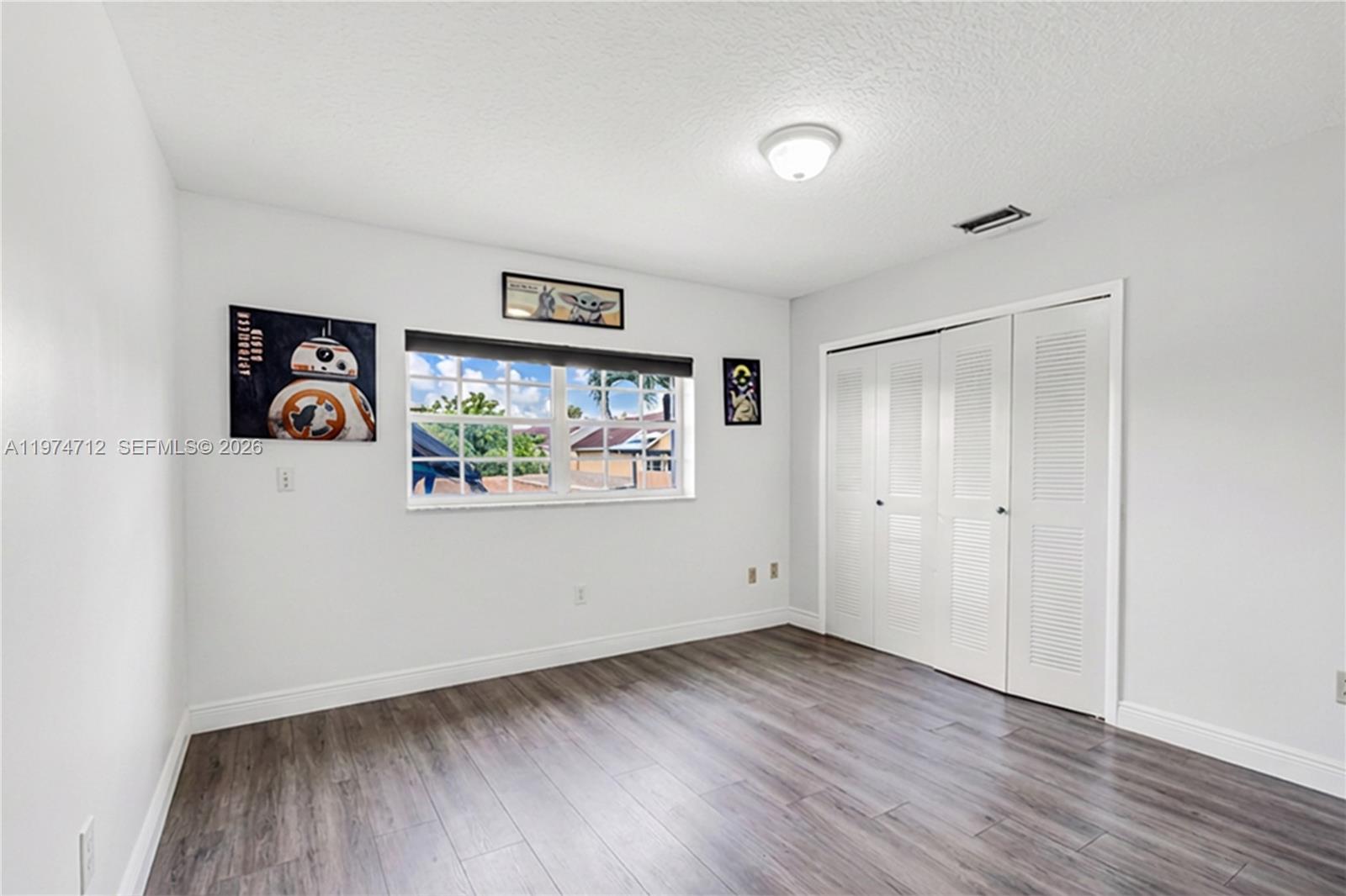 12775 Southwest 59th Street Miami, FL 33183 - Photo 14 of 18 a view of a hallway with wooden floor and closet