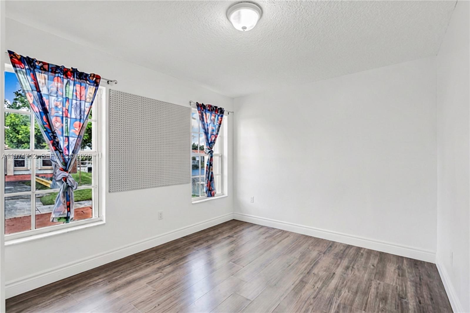 12775 Southwest 59th Street Miami, FL 33183 - Photo 15 of 18 an empty room with windows and entrance