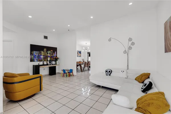 a living room with furniture and a lamp