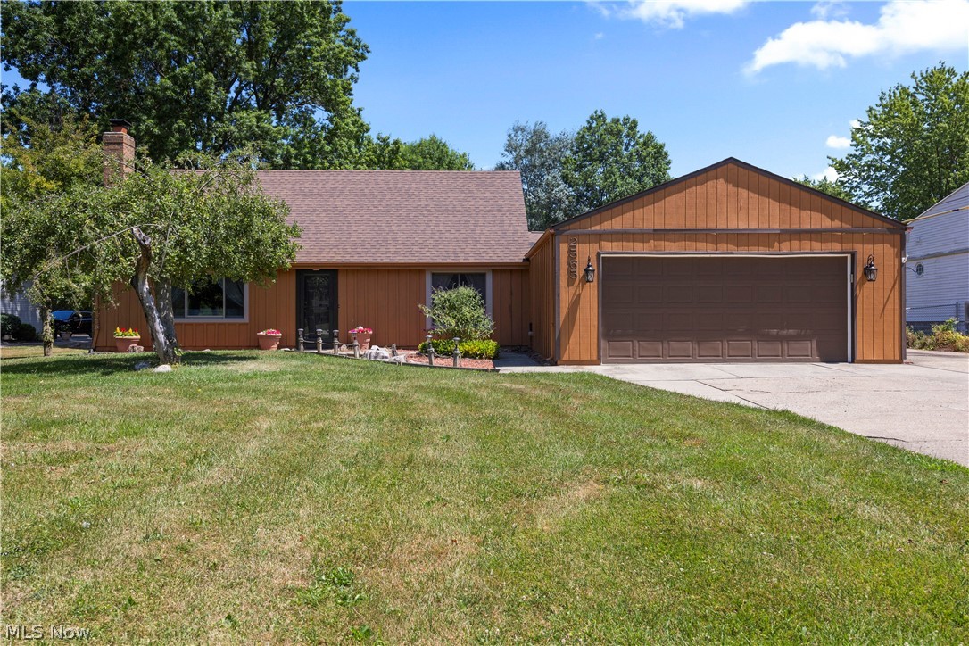 2565 Abbe Road North Sheffield Lake, OH 44054 - Photo 30 of 32 Single story home featuring a front lawn, concrete driveway, a shingled roof, and an attached garage