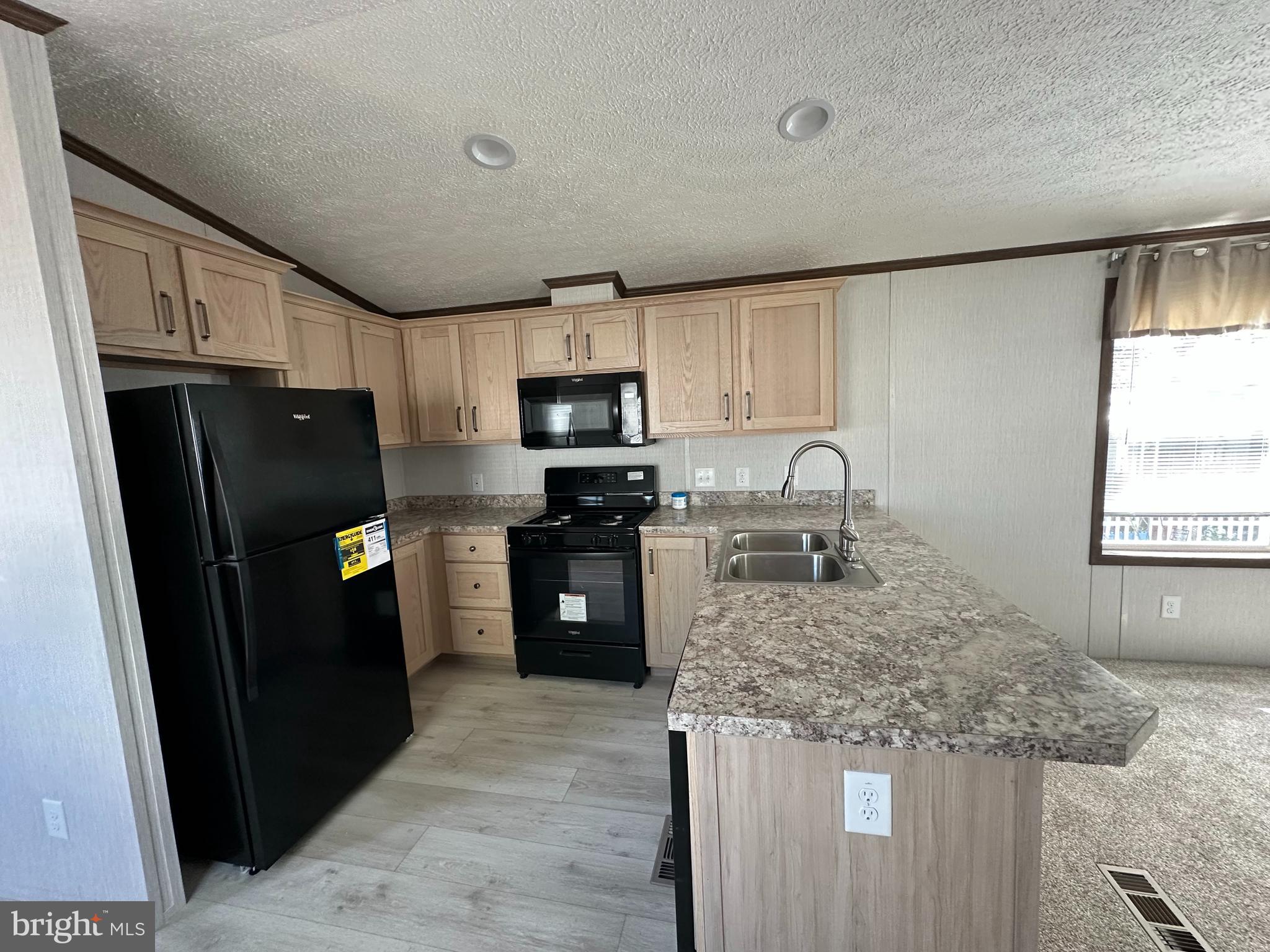 4540 Rolo Court Mechanicsburg, PA 17055 - Photo 3 of 11 a kitchen with granite countertop a refrigerator stove and sink