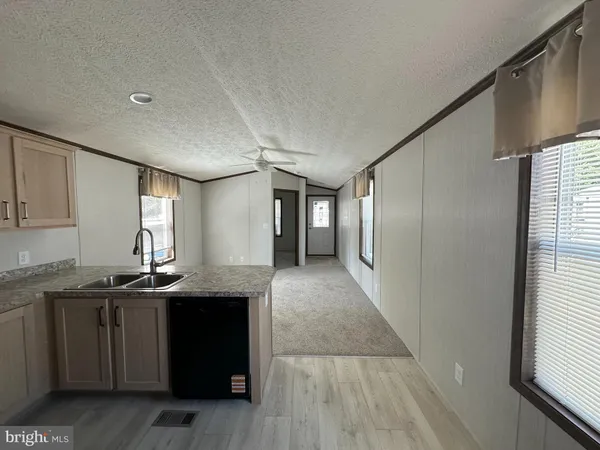 a kitchen with granite countertop a sink and cabinets