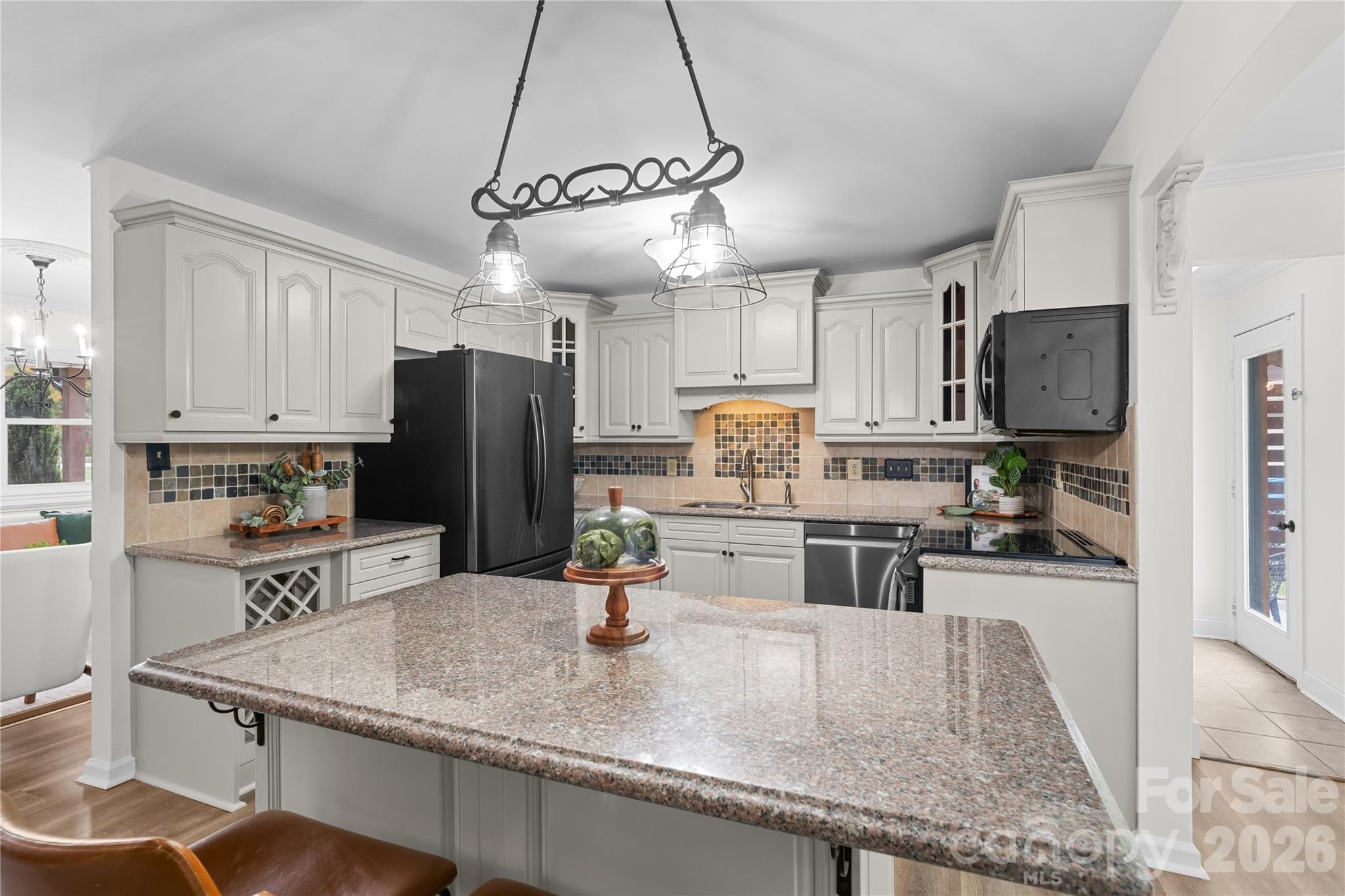 1335 Blacksnake Road Stanley, NC 28164 - Photo 9 of 31 a kitchen with stainless steel appliances granite countertop a sink refrigerator and microwave