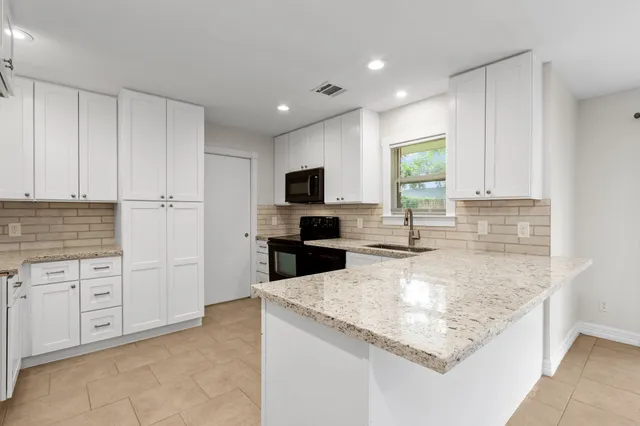 a kitchen with a sink stove and microwave
