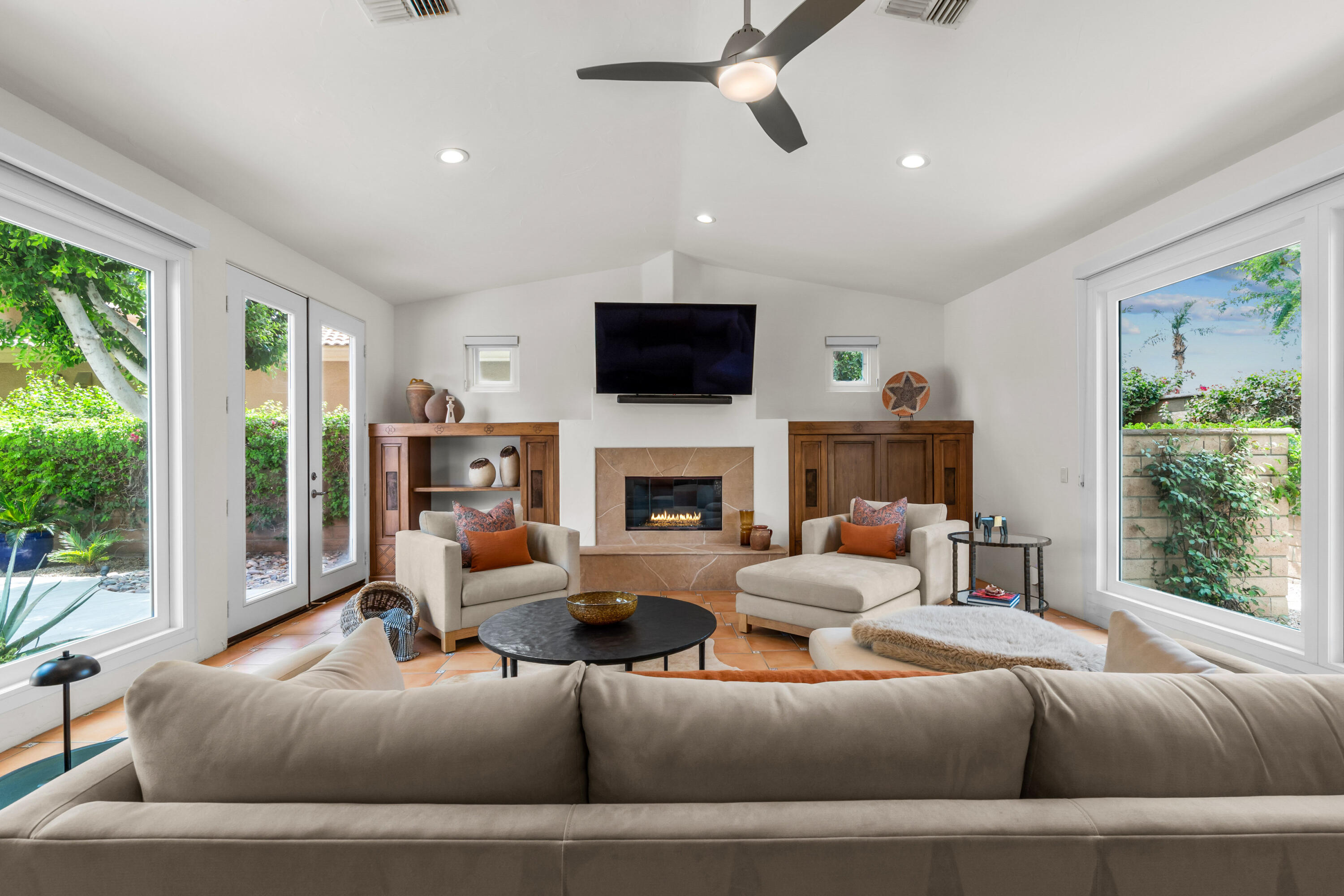 78900 Rio Seco La Quinta, CA 92253 - Photo 11 of 48 a living room with furniture a flat screen tv and a fireplace
