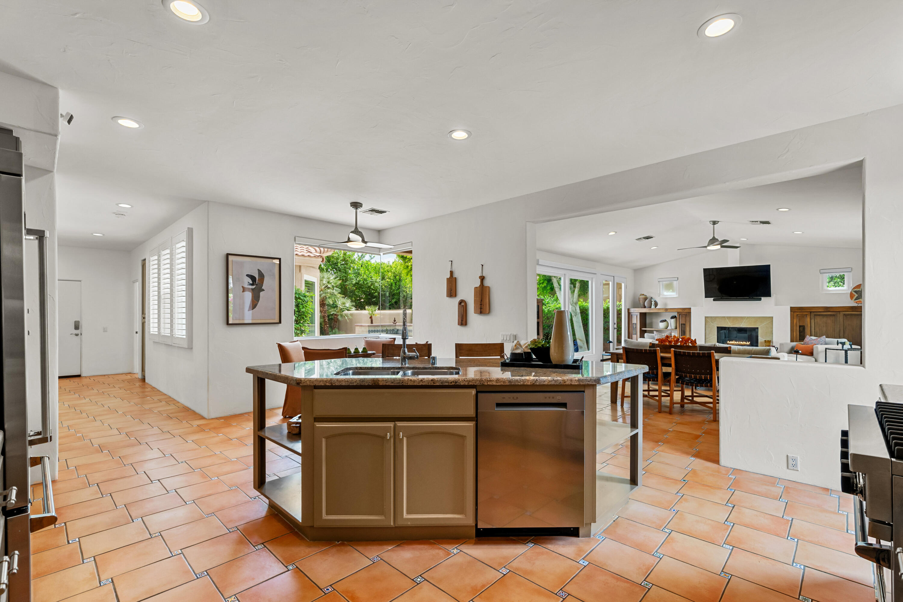 78900 Rio Seco La Quinta, CA 92253 - Photo 12 of 48 a kitchen with stainless steel appliances granite countertop a stove top oven a sink dishwasher and a refrigerator