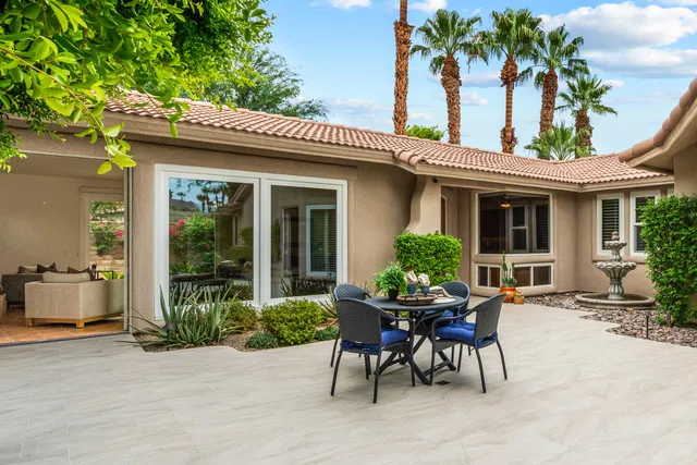 a view of a house with backyard sitting area and garden