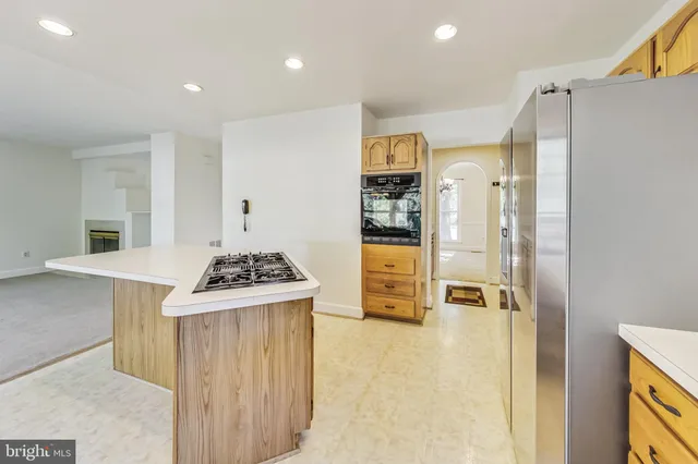 a kitchen with stainless steel appliances granite countertop a stove and a refrigerator