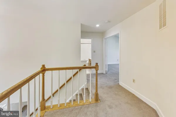 a spacious bathroom with a tub sink and mirror