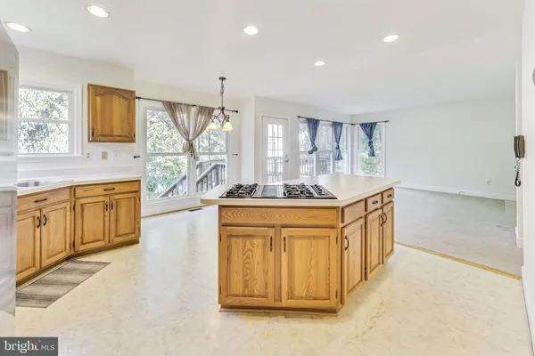 a bathroom with sink a mirror a bathtub and window