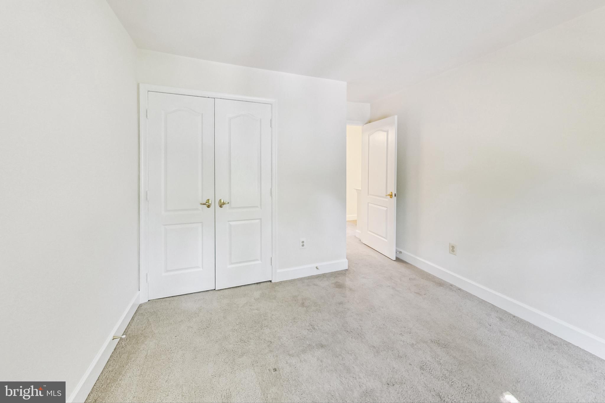 6104 Cool Spring Terrace South Frederick, MD 21701 - Photo 38 of 67 an empty room with white wall and closet