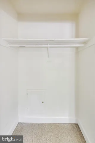 a front view of a house with a yard and potted plants