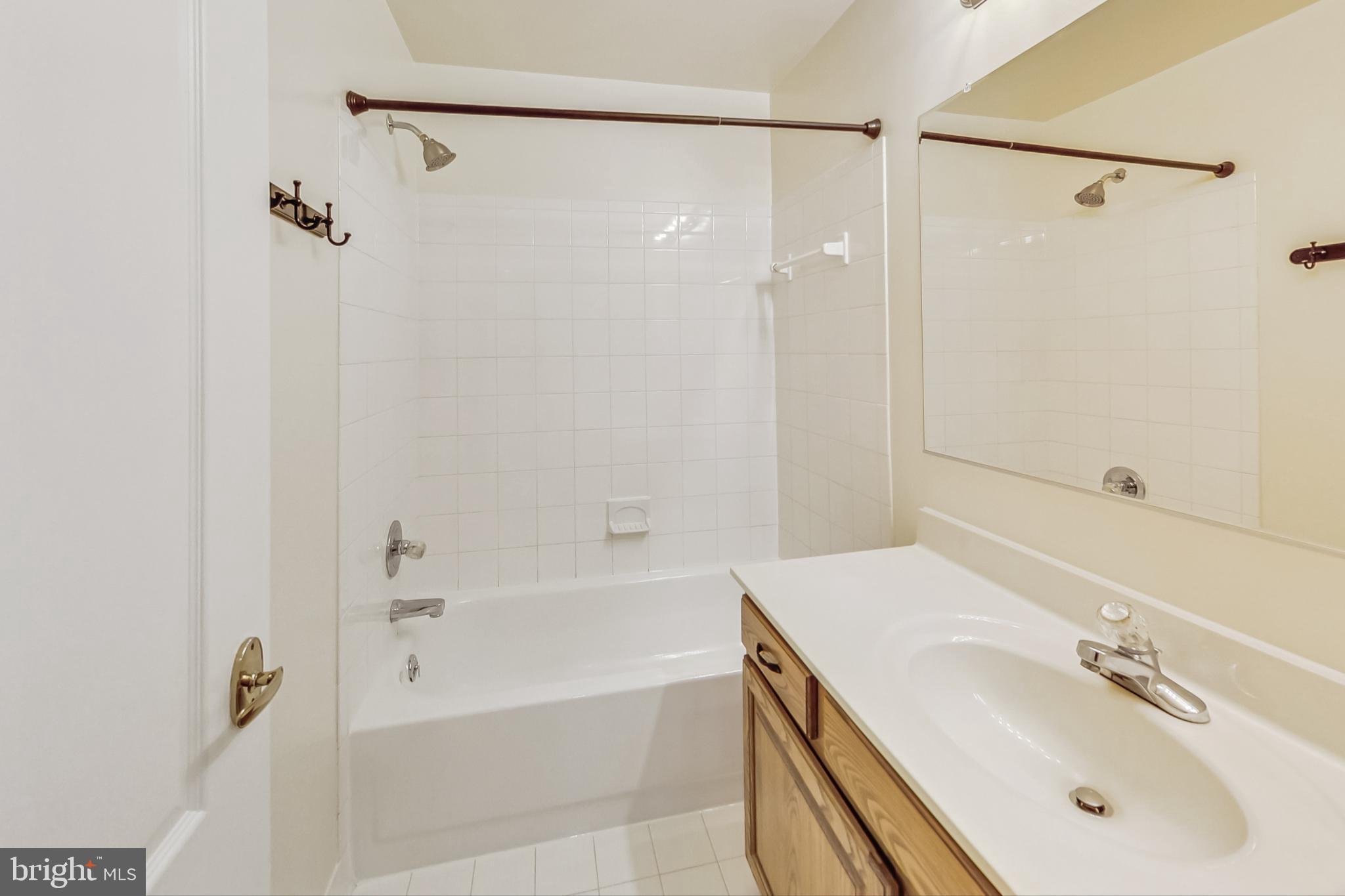 6104 Cool Spring Terrace South Frederick, MD 21701 - Photo 40 of 67 a bathroom with a tub sink shower and mirror