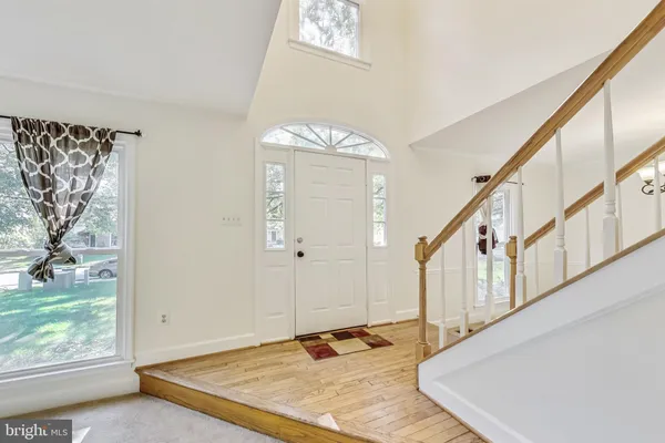 a view of an entryway with wooden floor