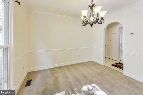 a view of a chandelier in big room with chandelier fan