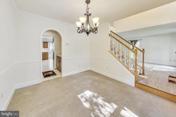 a view of entryway and hall with a chandelier