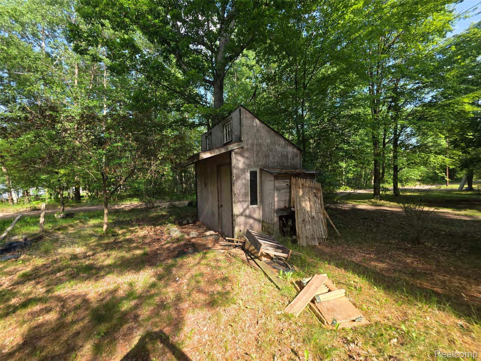5420 Randy Drive Prescott, MI 48756 - Photo 19 of 31 Rustic structure with natural wood siding situated within a wooded environment