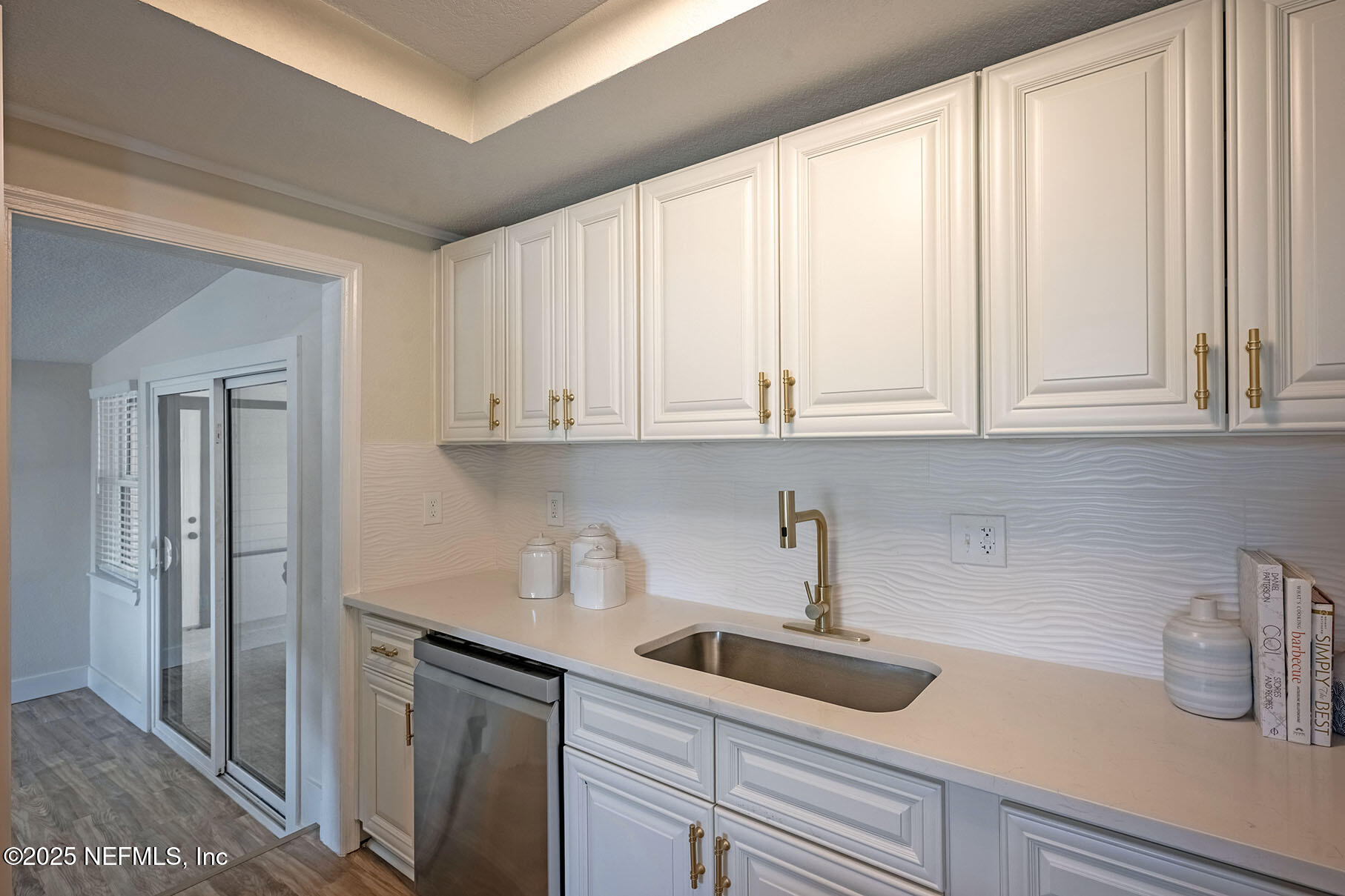 571 Hopkins Street Neptune Beach, FL 32266 - Photo 13 of 63 a kitchen with white cabinets and sink