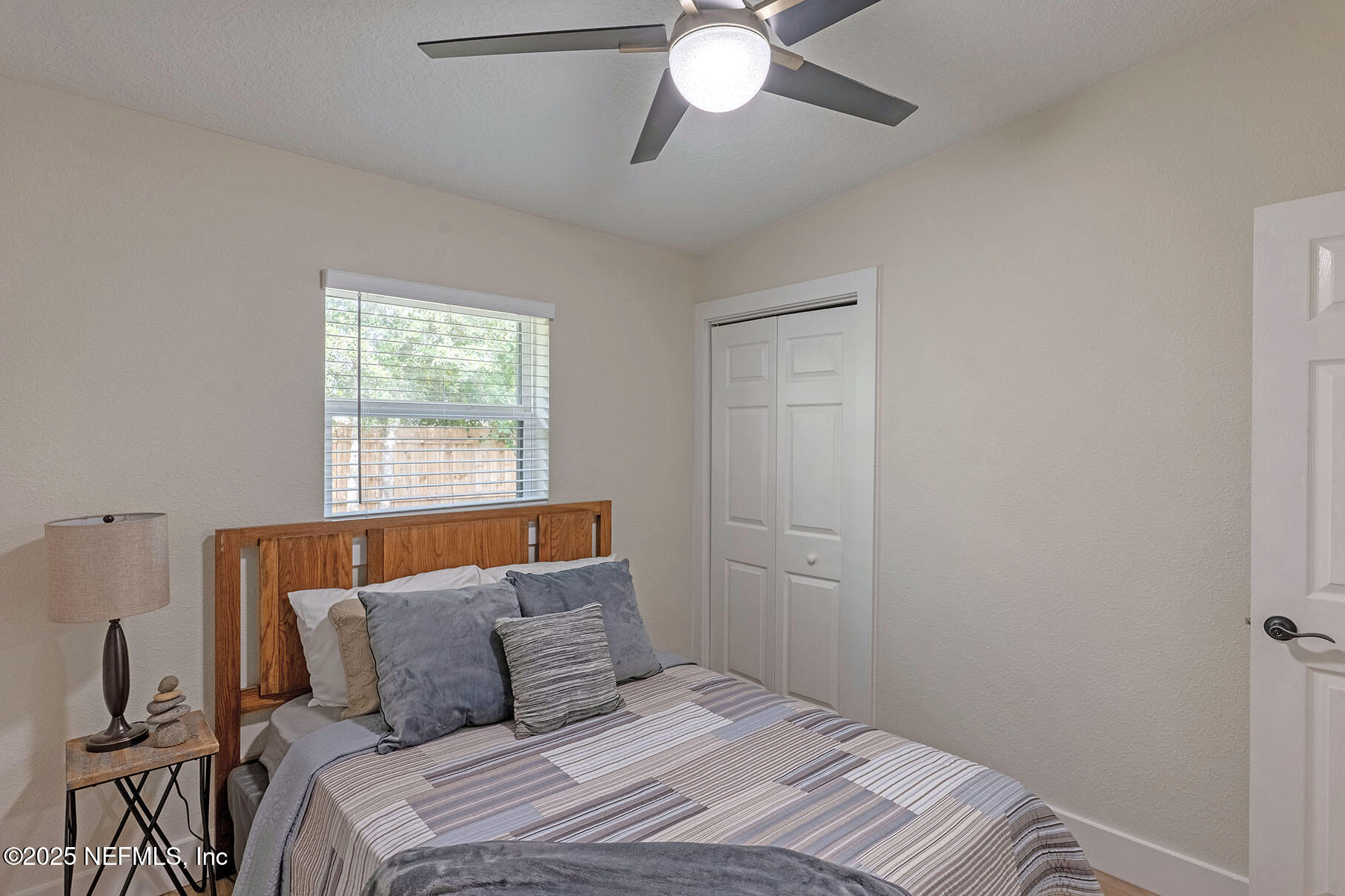 571 Hopkins Street Neptune Beach, FL 32266 - Photo 27 of 63 a bedroom with a bed and a chandelier
