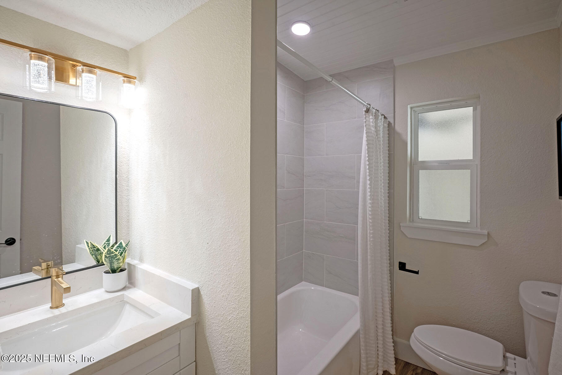 571 Hopkins Street Neptune Beach, FL 32266 - Photo 29 of 63 a bathroom with a granite countertop sink toilet and shower