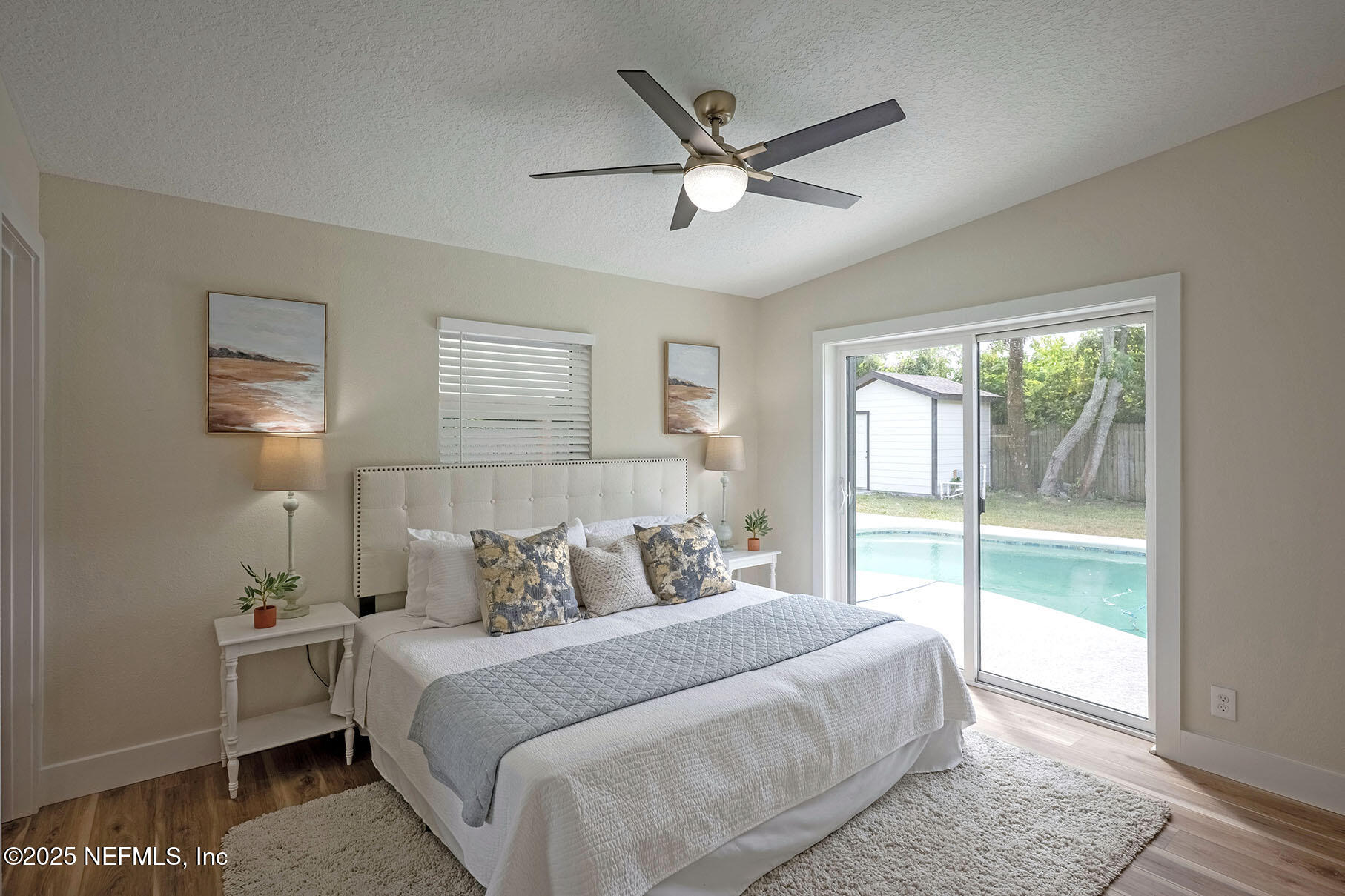 571 Hopkins Street Neptune Beach, FL 32266 - Photo 35 of 63 a bedroom with a large bed and a window