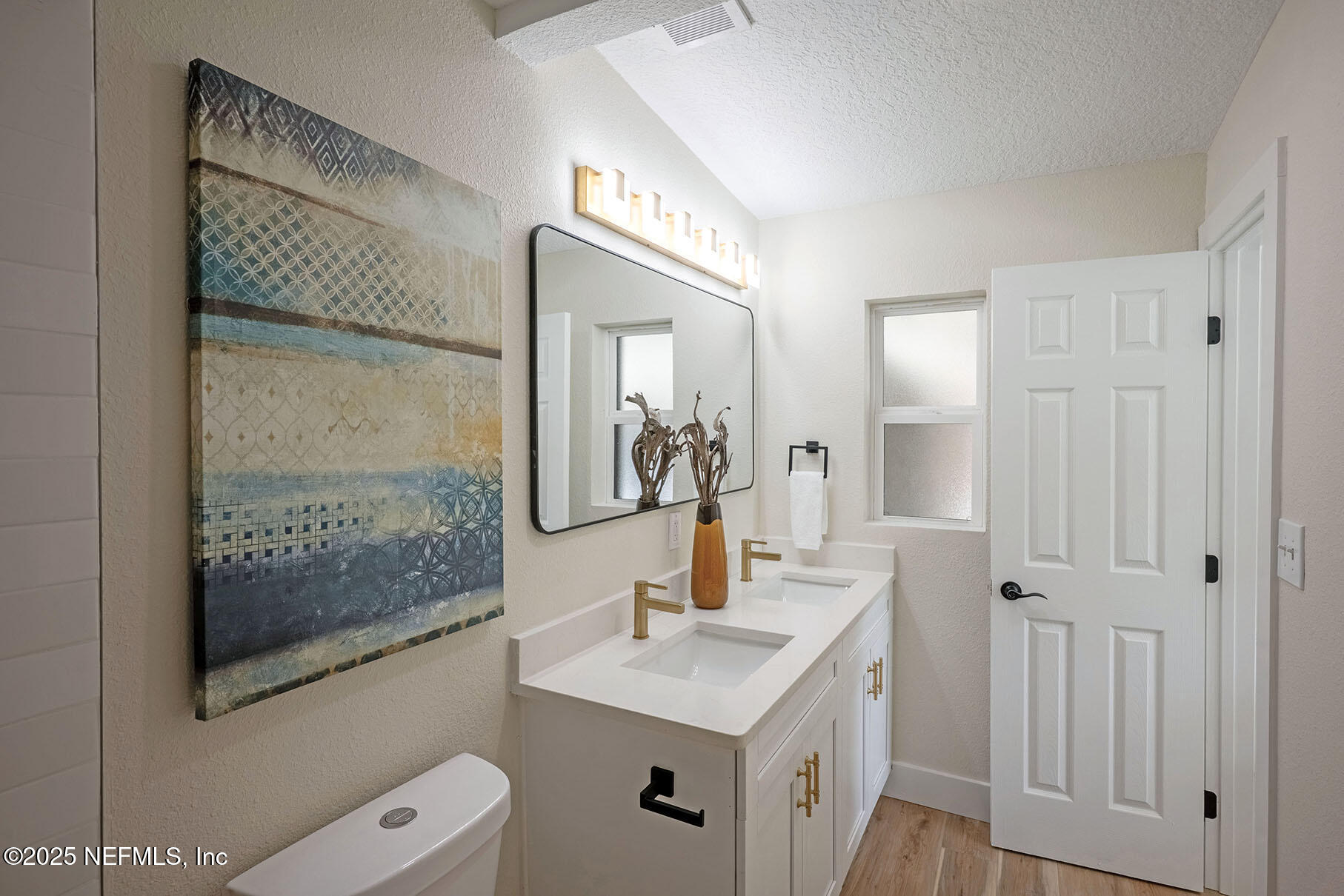 571 Hopkins Street Neptune Beach, FL 32266 - Photo 41 of 63 a bathroom with a sink a toilet a mirror and shower