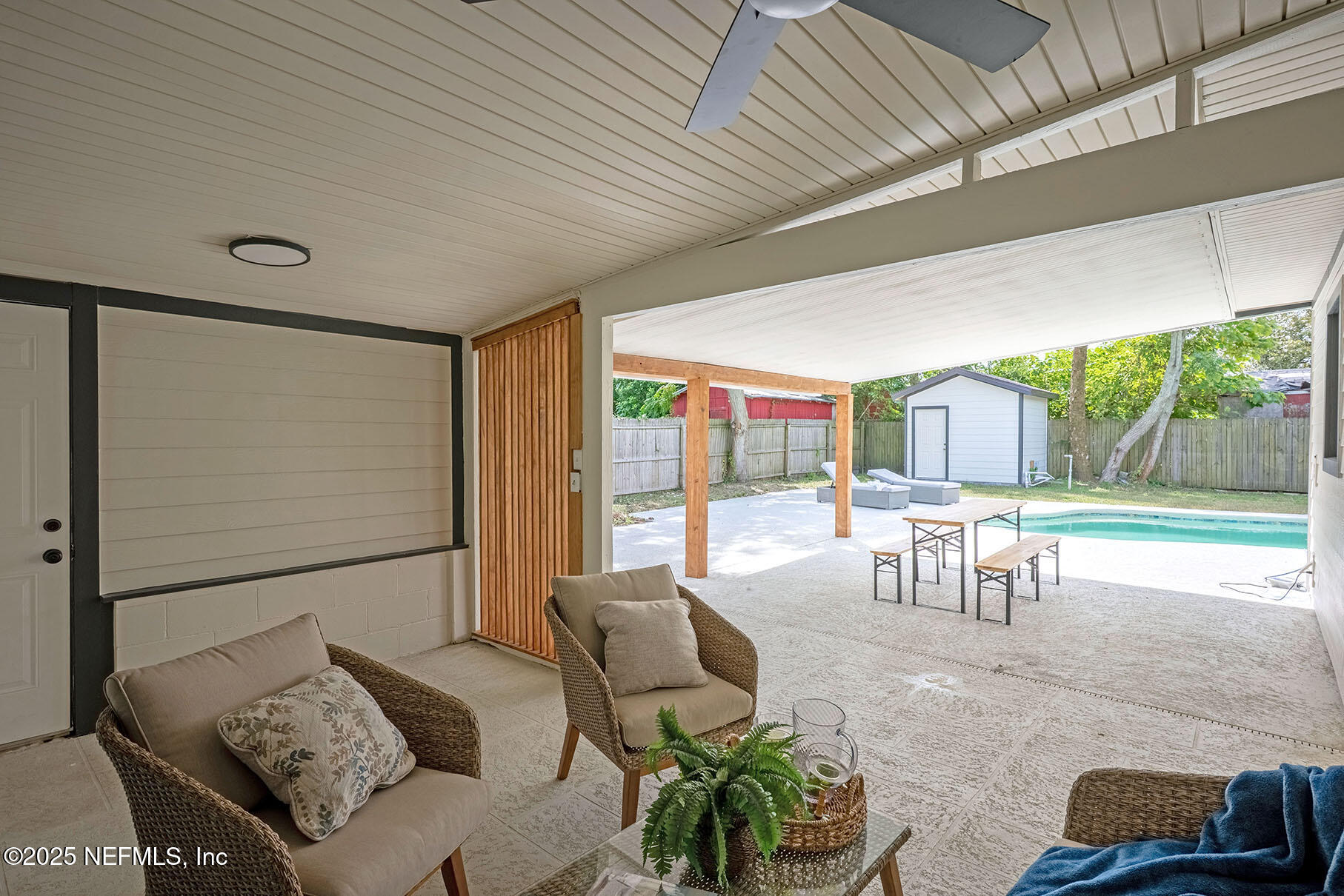 571 Hopkins Street Neptune Beach, FL 32266 - Photo 46 of 63 a living room with furniture and a floor to ceiling window