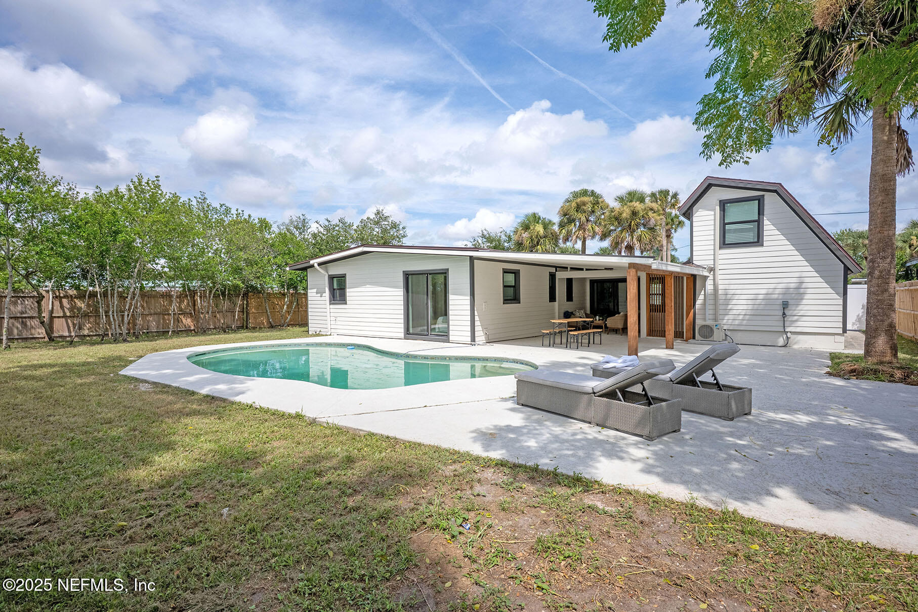 571 Hopkins Street Neptune Beach, FL 32266 - Photo 49 of 63 a view of a house with backyard and sitting area