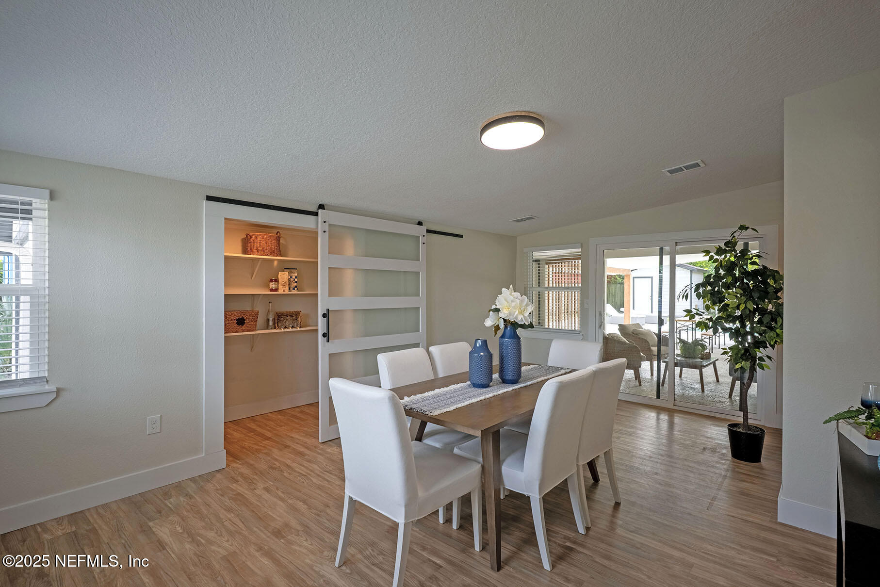 571 Hopkins Street Neptune Beach, FL 32266 - Photo 6 of 63 a view of a dining room with furniture and wooden floor