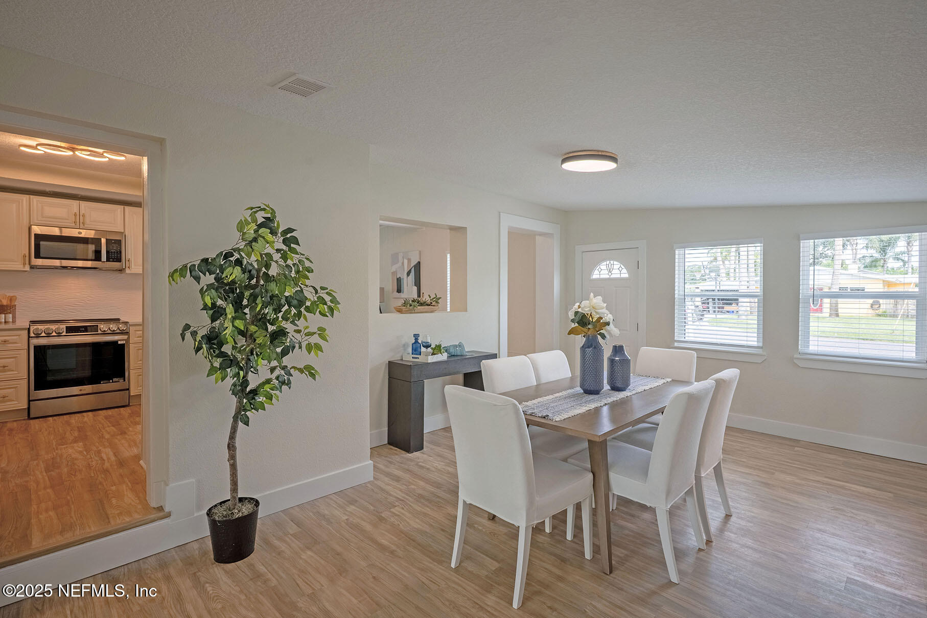 571 Hopkins Street Neptune Beach, FL 32266 - Photo 7 of 63 a view of a dining room with furniture window and wooden floor