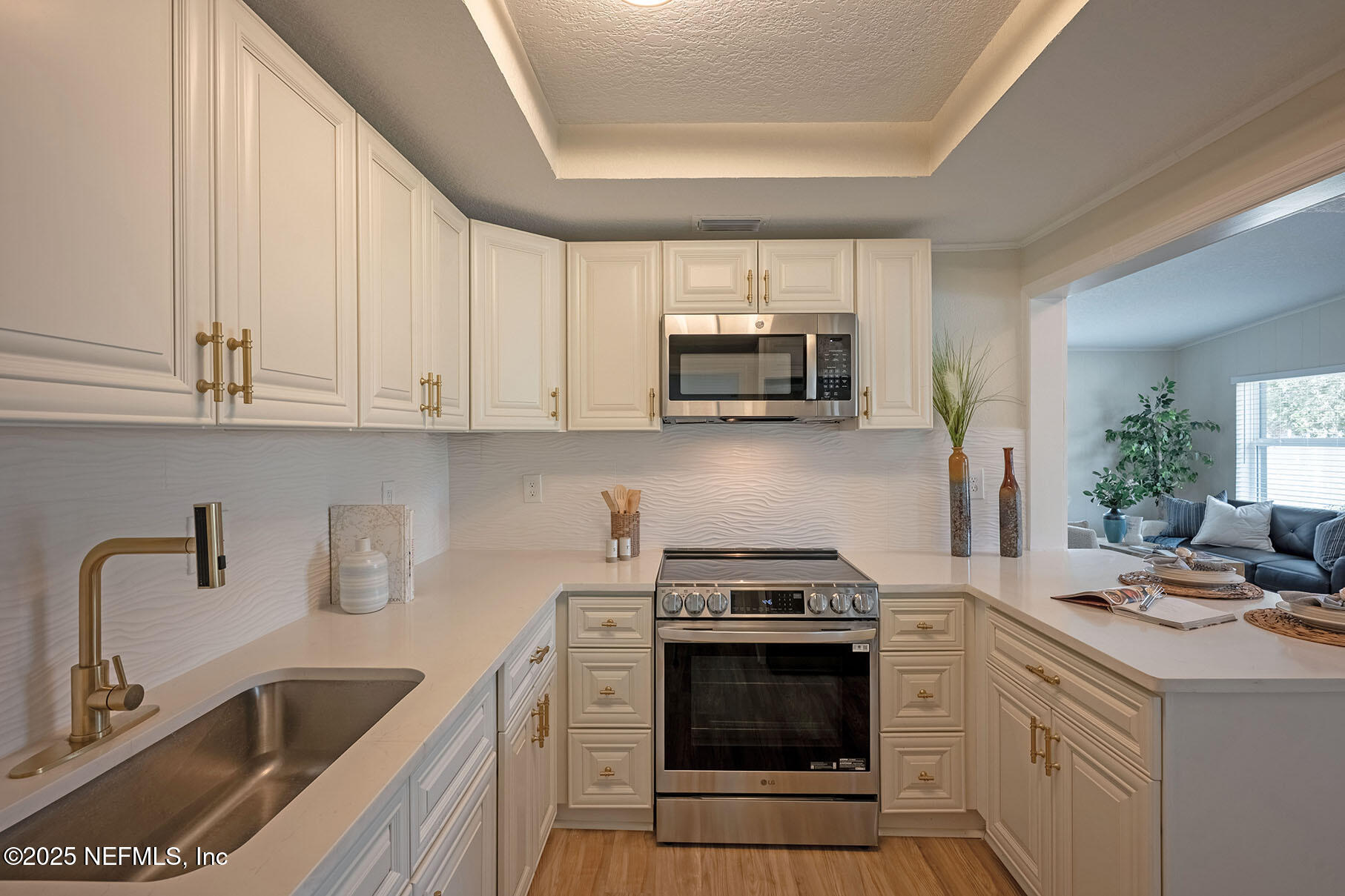 571 Hopkins Street Neptune Beach, FL 32266 - Photo 8 of 63 a kitchen with a sink stove and microwave